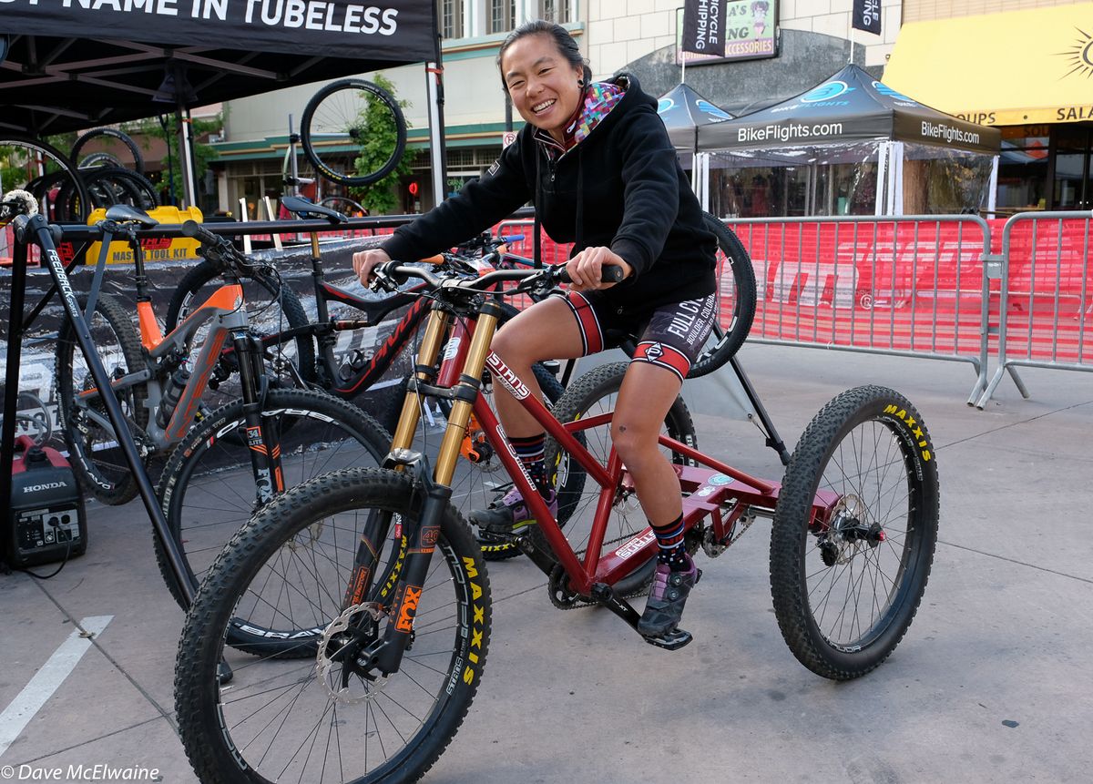 Evelyn Dong (Full Cycled) riding a big tricycle prior to her race