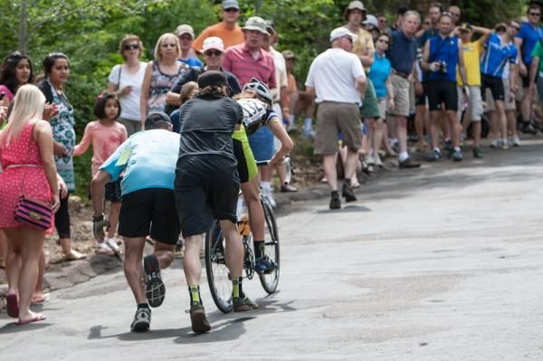 Fans help a rider who came off on the climb.