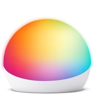 A product render of the Amazon Echo Glow with rainbow colored lights