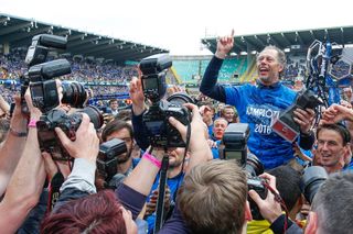 Club Brugge coach Michel Preud'homme celebrates in front of photographers after winning the Belgian Pro League in 2016.