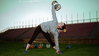 Woman performs kettlebell windmill