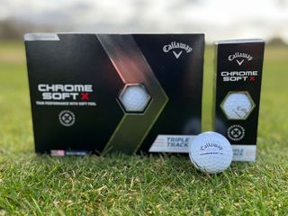 A box of Callaway Chrome Soft X Golf Balls, callaway golf balls with grass background