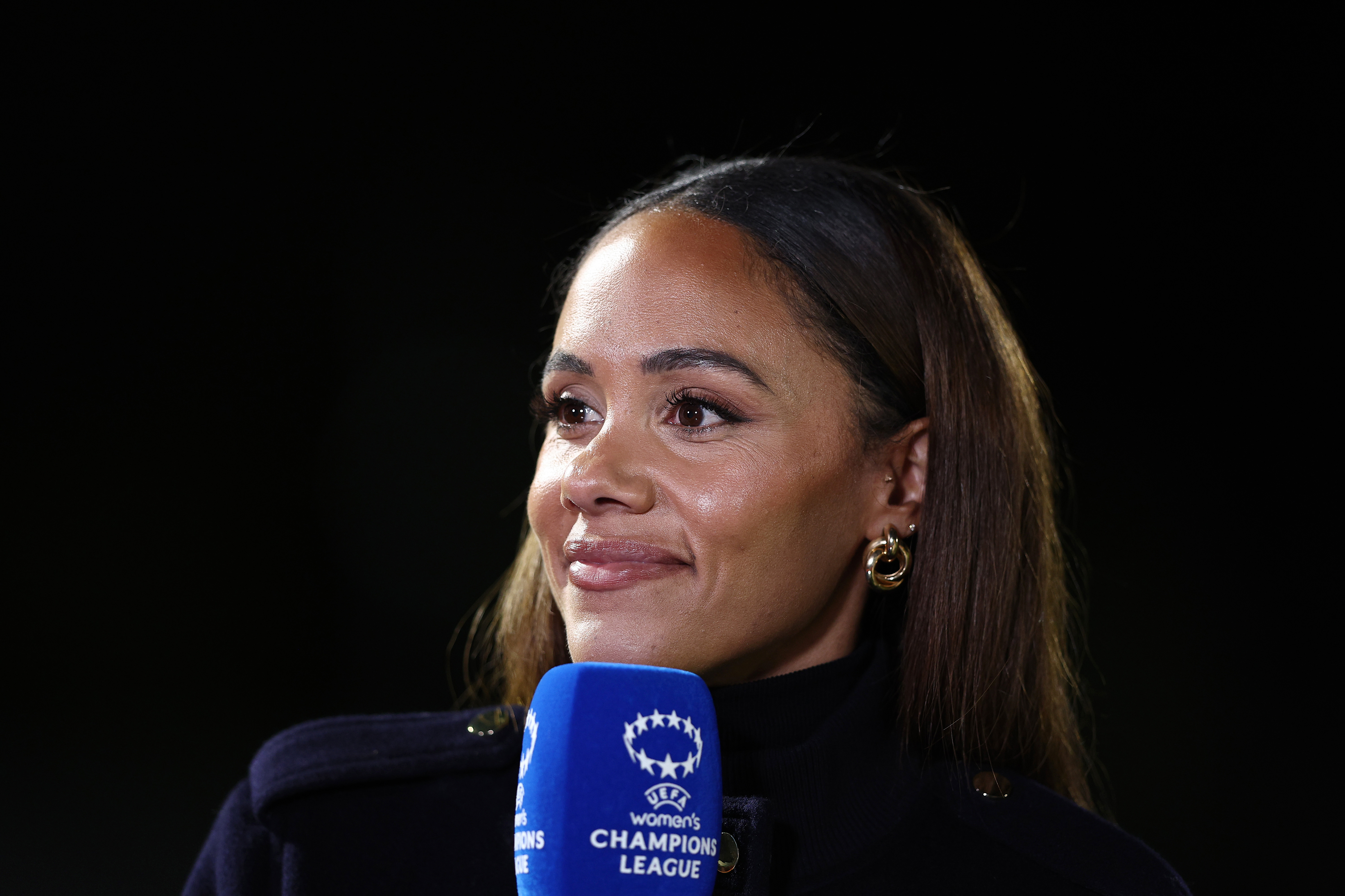 BOREHAMWOOD, ENGLAND - OCTOBER 07: Alex Scott MBE, English former football player and current television presenter, looks on following the UEFA Women's Champions League 2025/26 league phase match between Arsenal FC and OL Lyonnes at Meadow Park on October 07, 2025 in Borehamwood, England. 