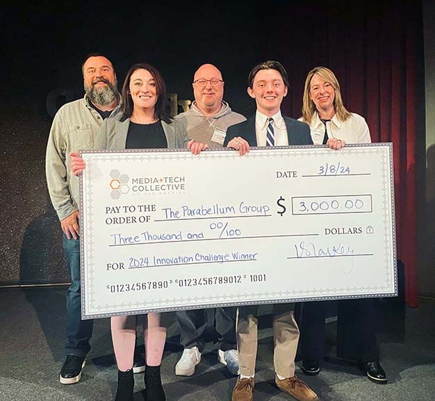 Team &ldquo;Parabellum Group&rdquo; from the University of Denver celebrate their win at the 17th annual Media+Tech Collective of the Rockies Innovation Challenge competition. (From l.): judge Mark Bridges of CableLabs, winner Lis McLaughlin, judge David Sedlock of Zayo, winner Benjamin Shorb and judge Brooke Puter of Comcast.