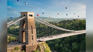 Clifton Suspension Bridge, Bristol, with balloons from Bristol Balloon Fiesta flying overhead