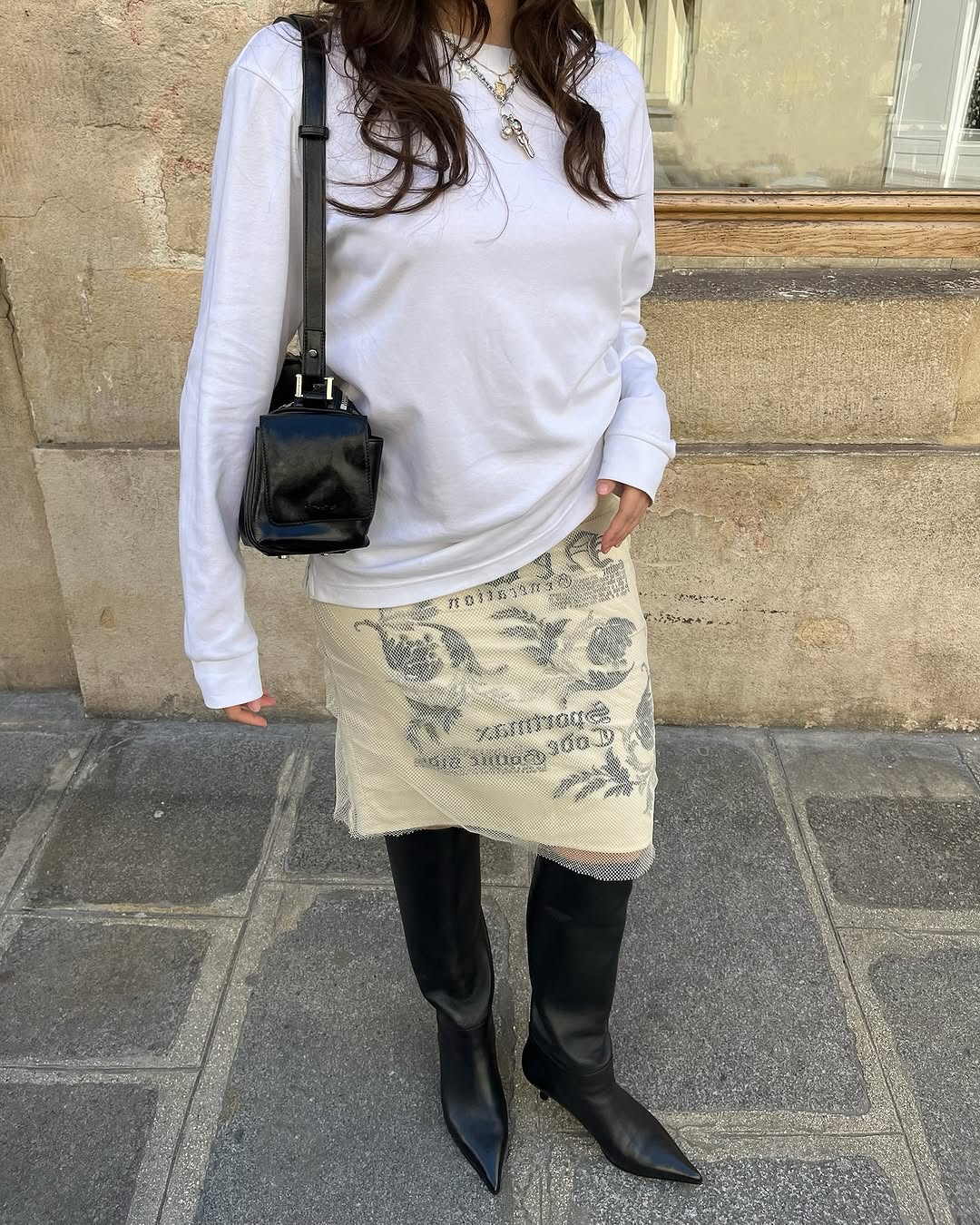 Woman wearing knee-length skirt outfit summer 2025.