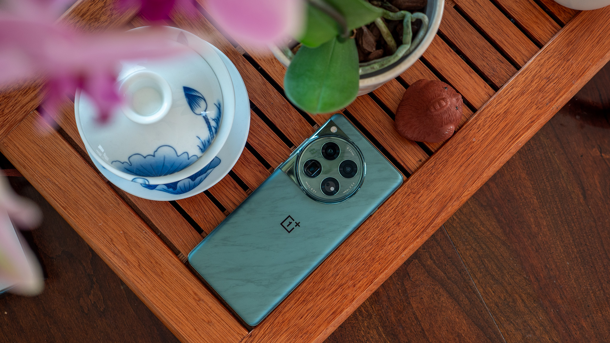 The OnePlus 12's green marble-like back