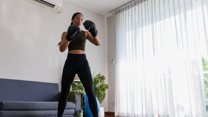 Woman doing boxing in living room