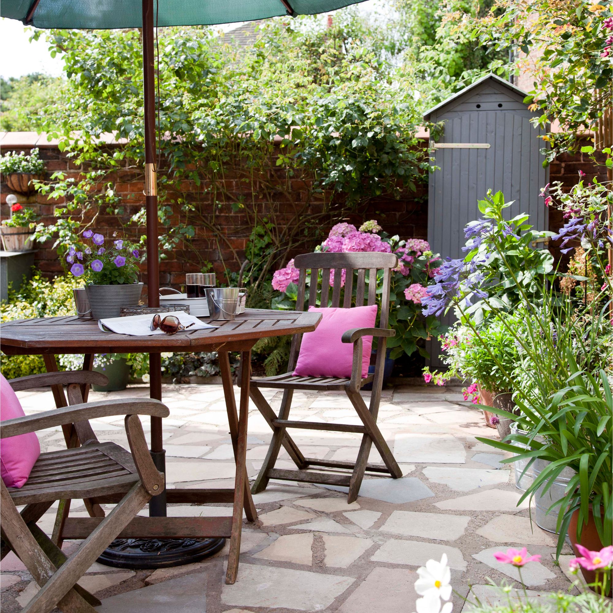 A small garden with rustic patio and plants