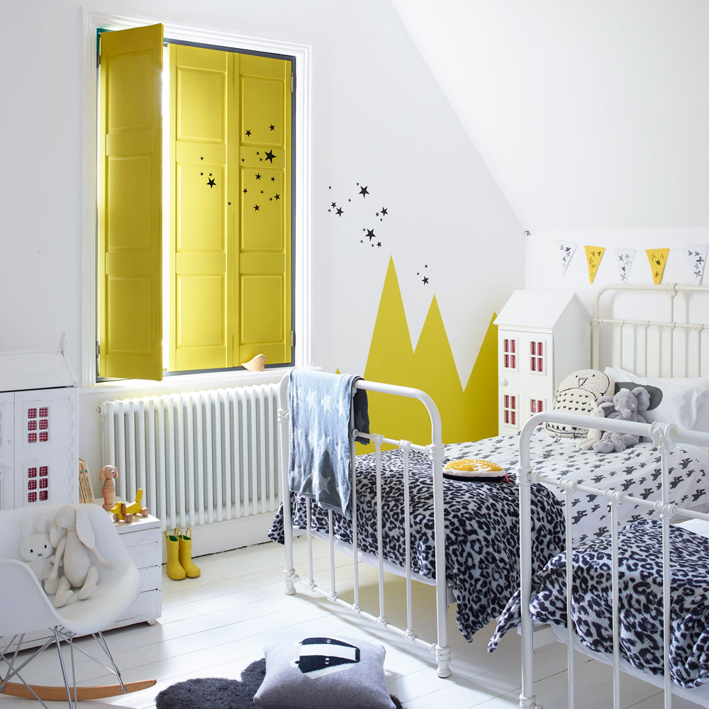white kids room with twin beds and yellow wooden shutters
