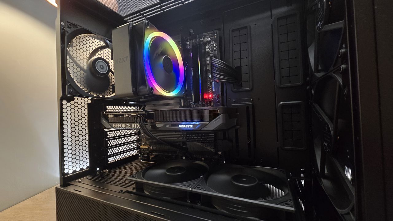 A Lian Li Lancool 217 on a desk with various components installed inside it.