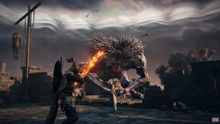 the ironeye archer class weilding a flaming bow against a big ogre