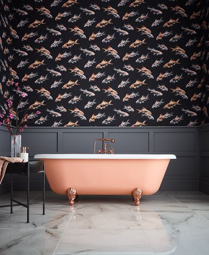 Salmon bath with gray wallpaneling and upper half wallpapered wall in modern fish print
