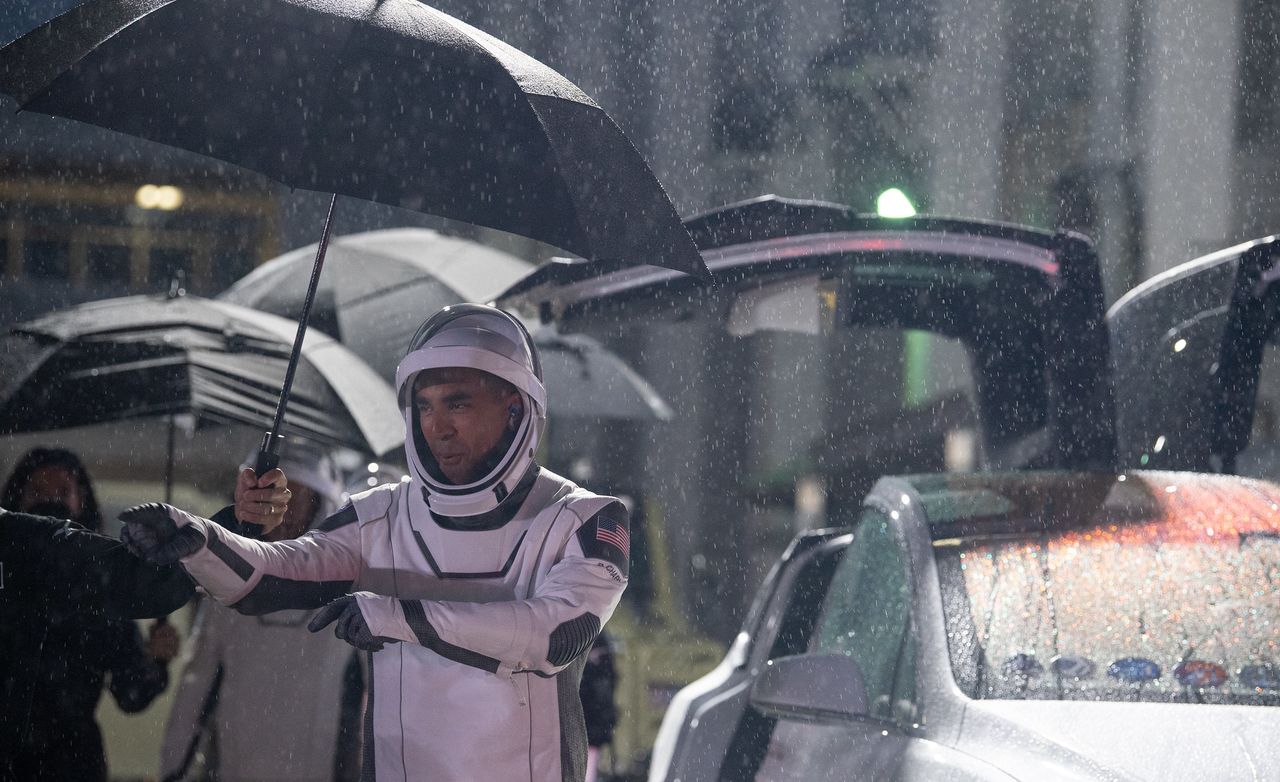 NASA astronaut Raja Chari, wearing a SpaceX spacesuit, points towards friends and family as he prepares to depart the Neil A. Armstrong Operations and Checkout Building for Launch Complex 39A to board the SpaceX Crew Dragon spacecraft for the Crew-3 mission launch, Wednesday, Nov. 10, 2021, at NASA&rsquo;s Kennedy Space Center in Florida.