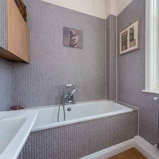 bathroom with bathtub and mosaic tiles