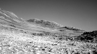 a black and white image of the side of a mountain, including a ridgeline, on Mars