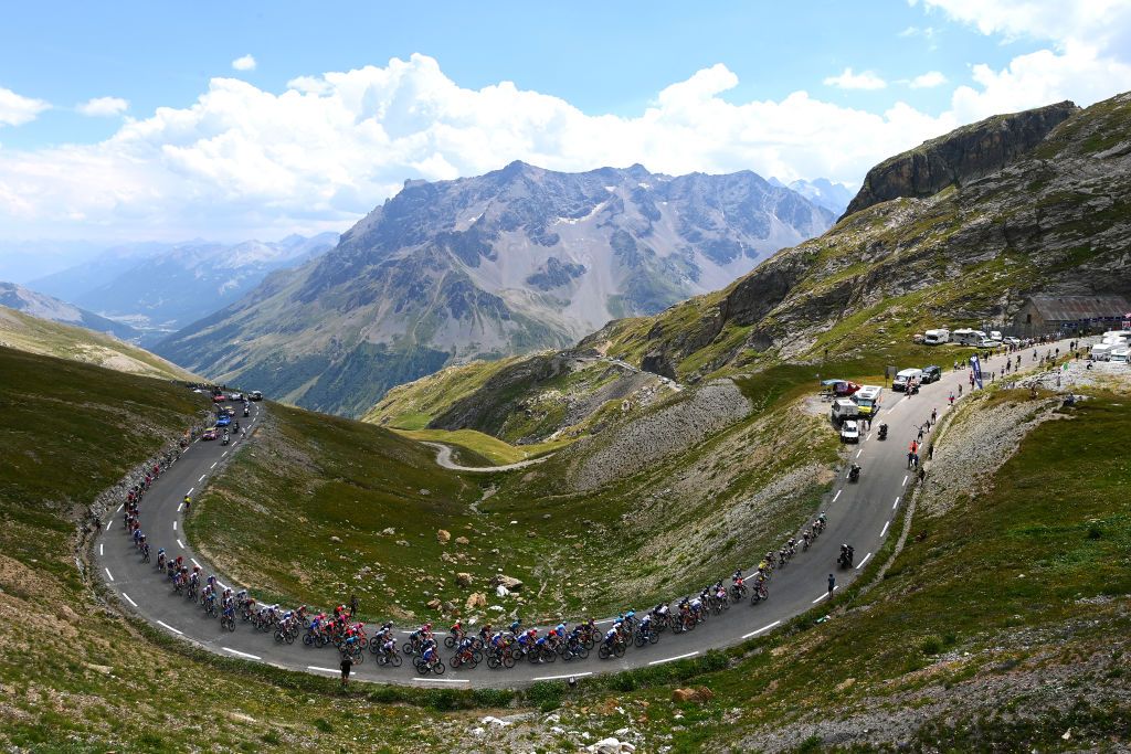 ALPE DHUEZ FRANCE JULY 14 A general view of Simon Geschke of Germany and Team Cofidis Polka Dot Mountain Jersey Tadej Pogacar of Slovenia and UAE Team Emirates white best young jersey Wout Van Aert of Belgium Green Points Jersey Jonas Vingegaard Rasmussen of Denmark and Team Jumbo Visma Yellow Leader Jersey and the peloton compete beginning to climb the Col du Galibier 2619m mountain landscape during the 109th Tour de France 2022 Stage 12 a 1651km stage from Brianon to LAlpe dHuez 1471m TDF2022 WorldTour on July 14 2022 in Alpe dHuez France Photo by Tim de WaeleGetty Images