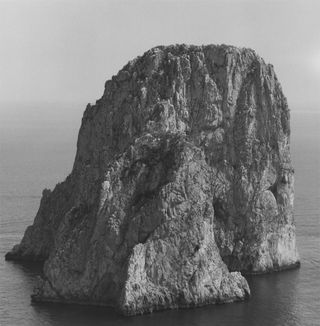 Gelatin silver print of a mountain surrounded by sea by Robert Mapplethorpe