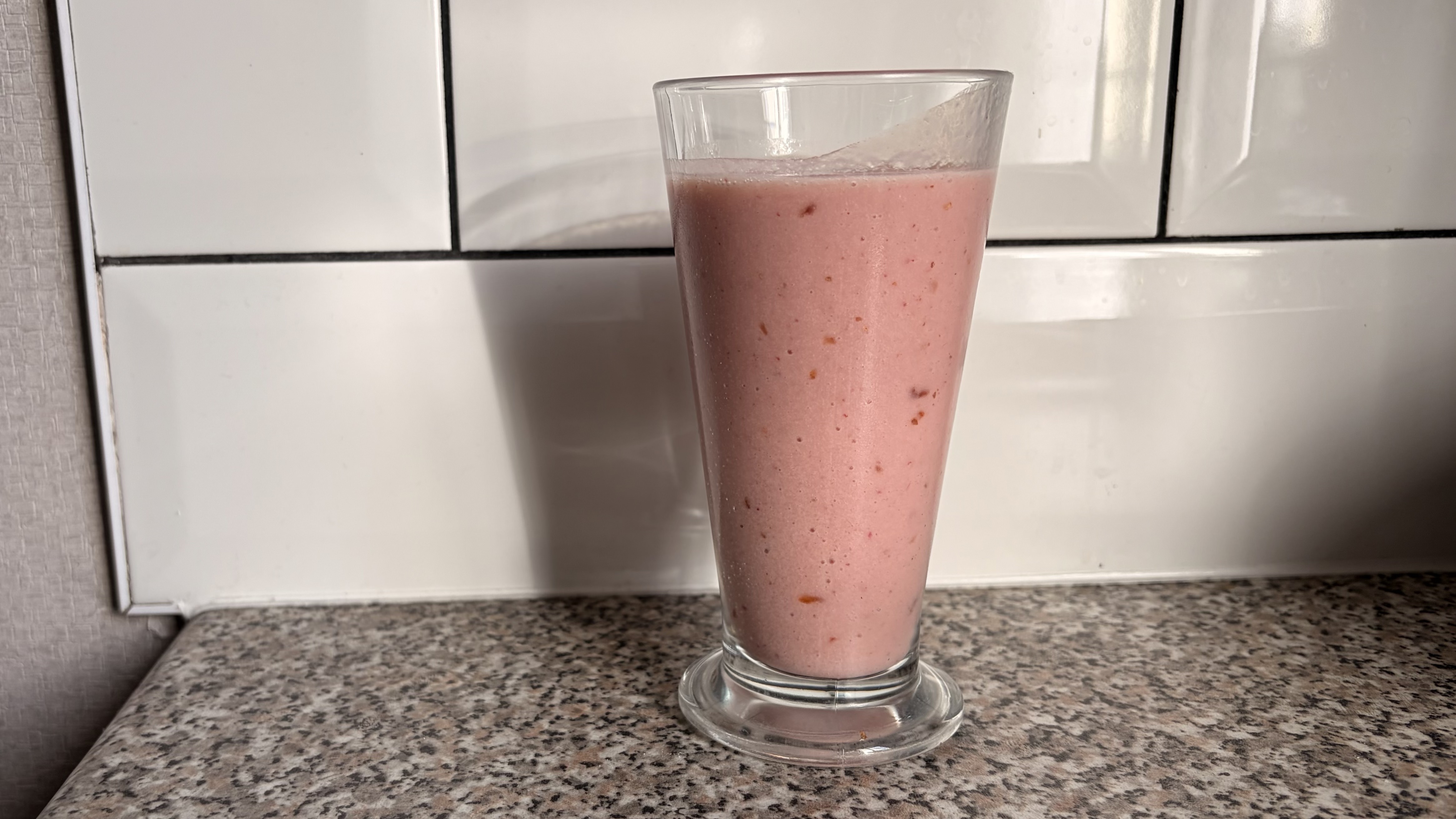 Smoothie made in the Nutribullet Flex blender photographed on a white background