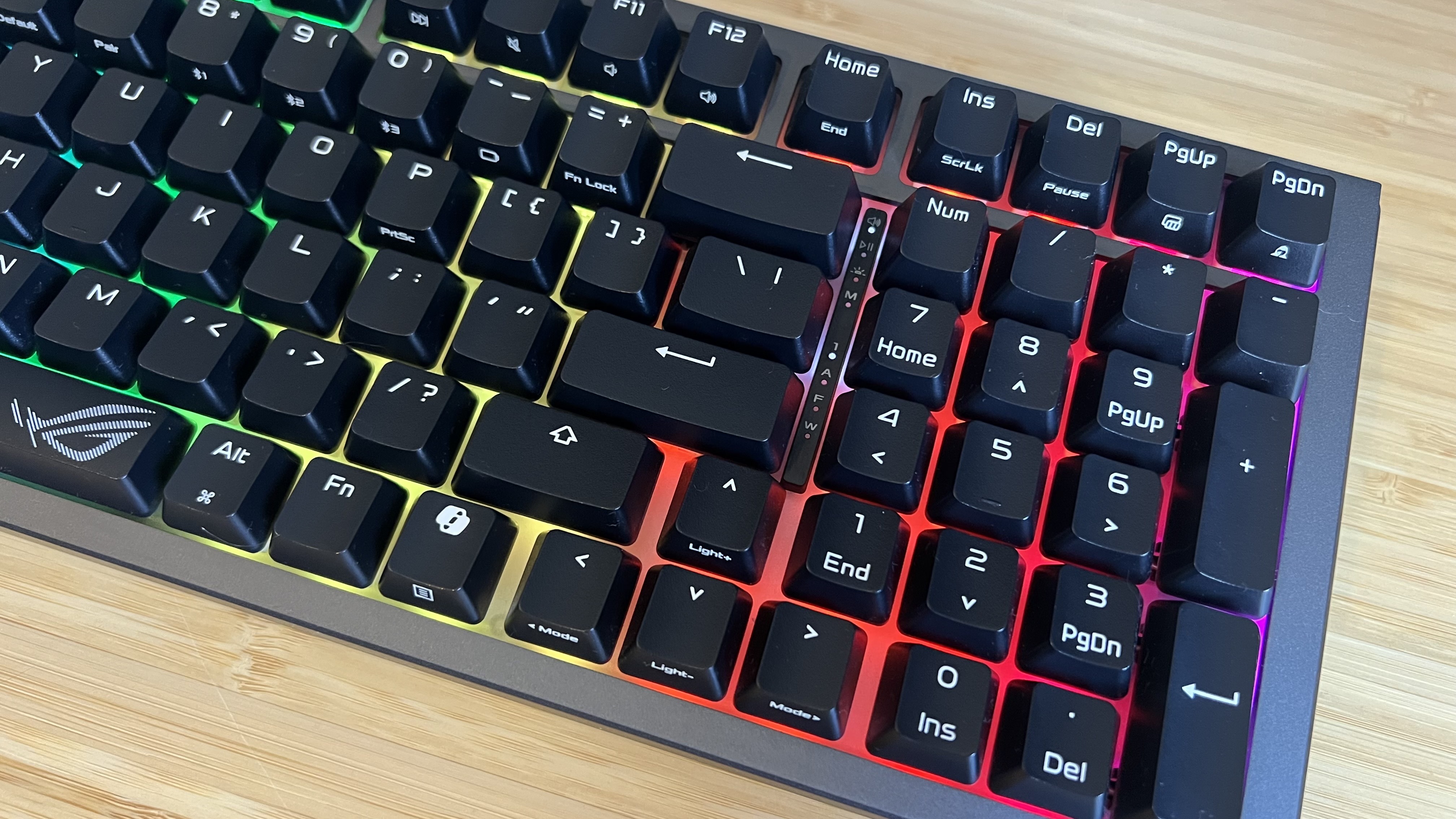 Top down view of Asus ROG Strix Morph 96 Wireless gaming keyboard showing spacing between number pad and main keys with RGB enabled