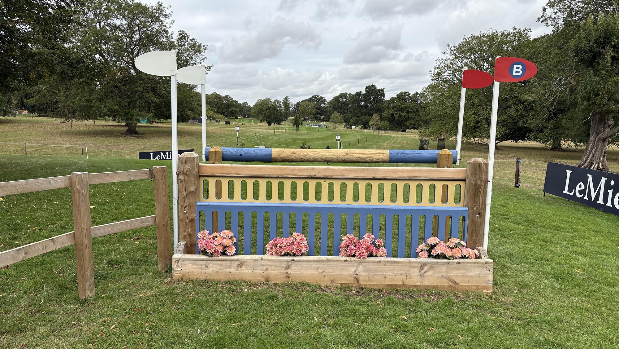 Wooden and blue painted spread fence on the Burghley cross-country course 2026
