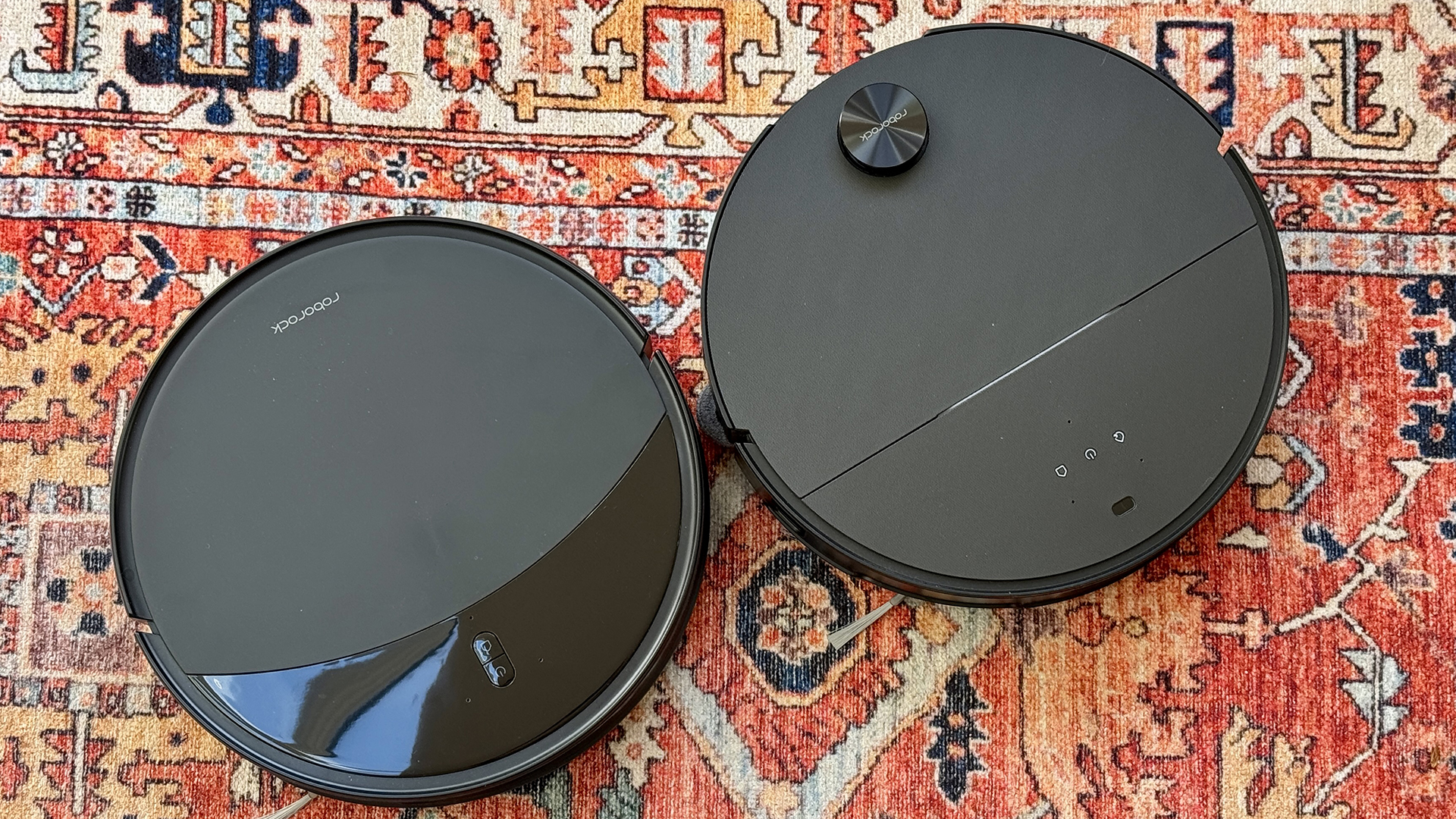 Roborock Saros 10R and Saros 10 robot vacuums side by side in reviewer's house