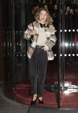 Gigi hadid leaves her hotel at Paris Fashion Week wearing a pair of dark wash jeans with a striped jacket