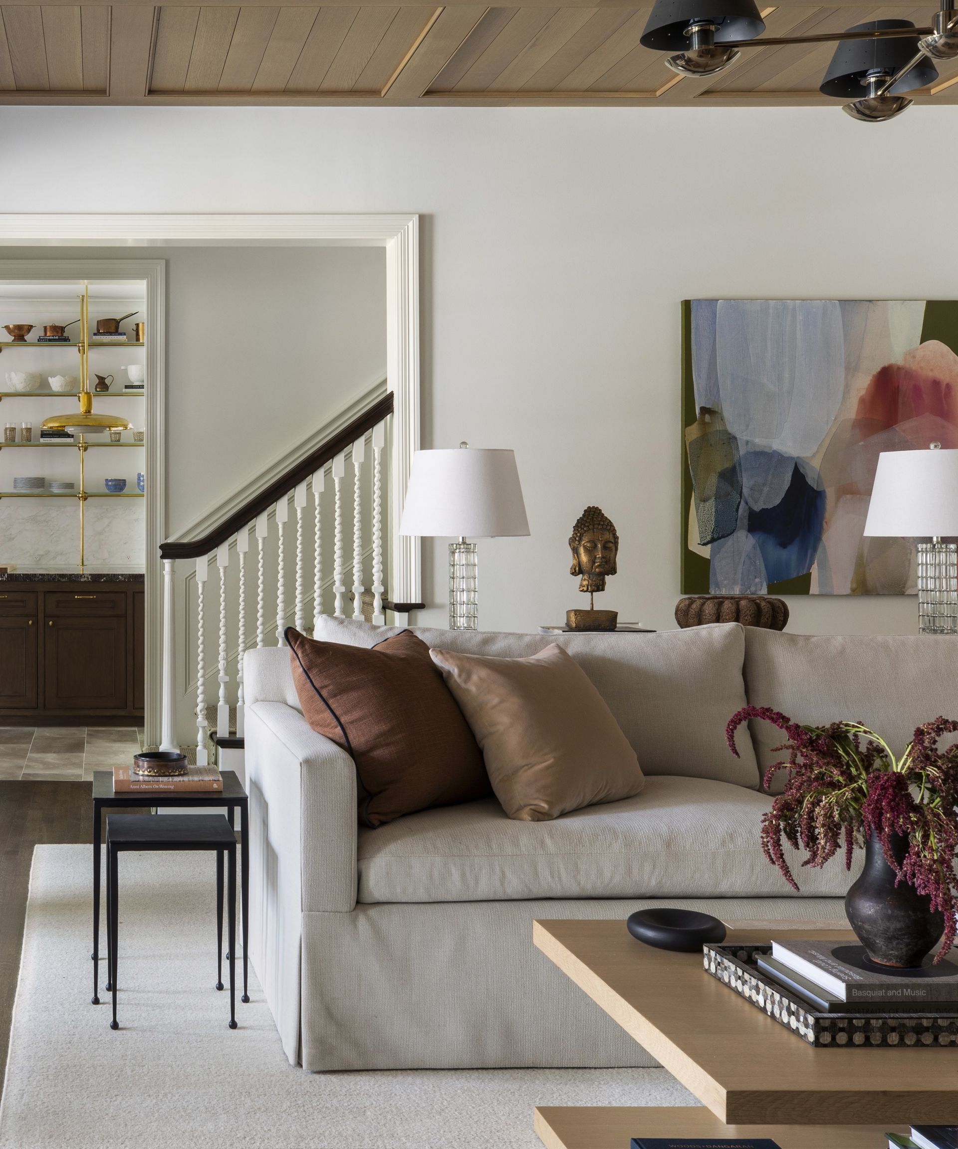 White living room with beige sofa and oversized art by Marie Flanigan