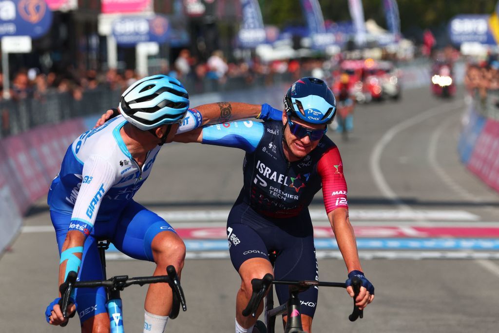 Israel Premier Techs Australian rider Simon Clarke R and de Team Jayco AlUlas Italian rider Alessandro De Marchi L celebrate as they crosse the finish line after cycling in a breakaway during the sixth stage of the Giro dItalia 2023 cycling race 162 km between Naples and Naples on May 11 2023 Photo by Luca Bettini AFP Photo by LUCA BETTINIAFP via Getty Images