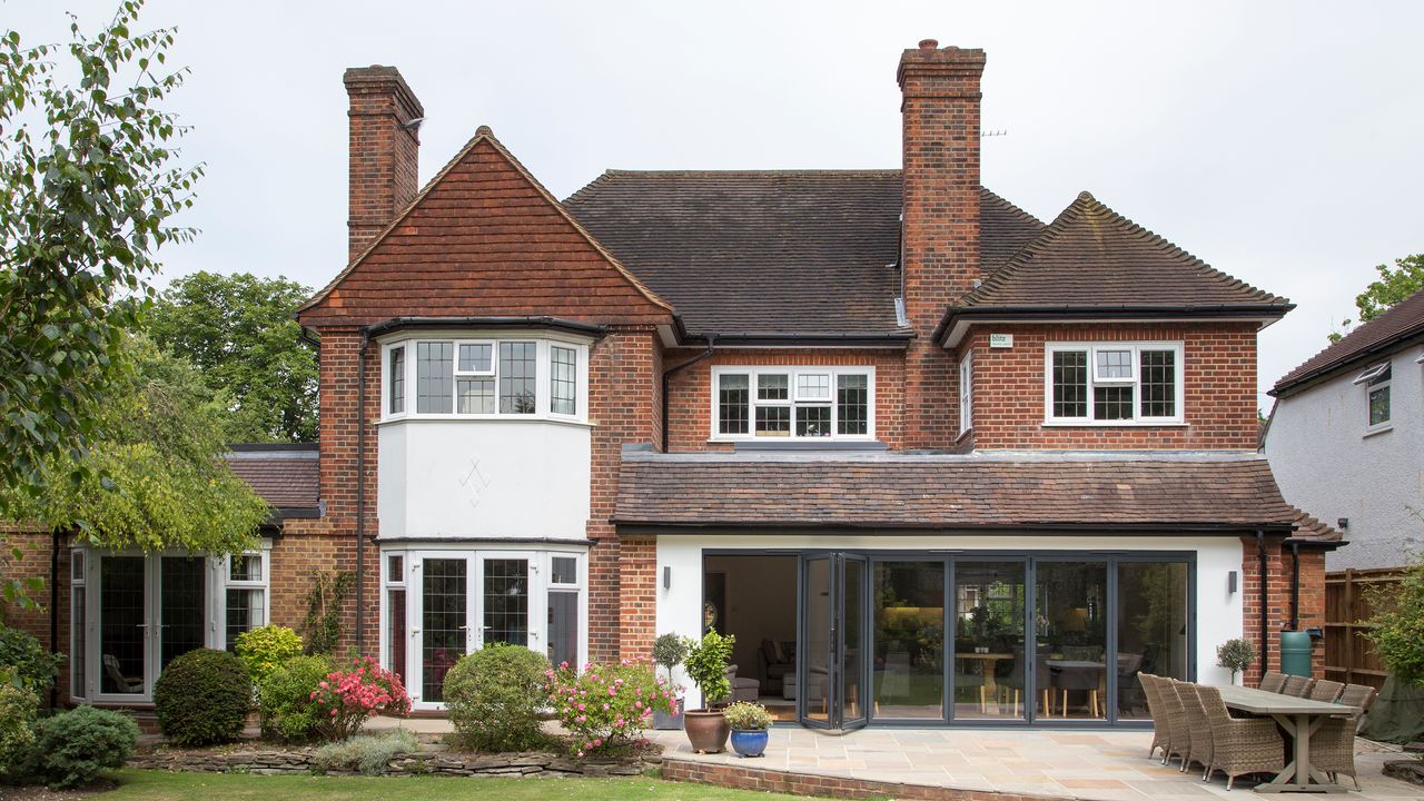 Exterior shot of the rear of a large detached house with single storey extension