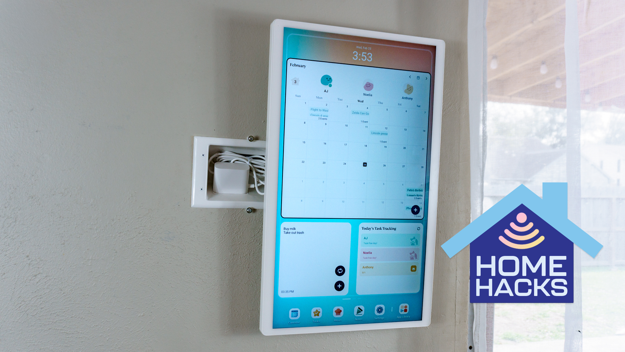 The Cozyla Calendar 2+ mounted on a wall with a recessed outlet behind it to hide its bulky power adapter