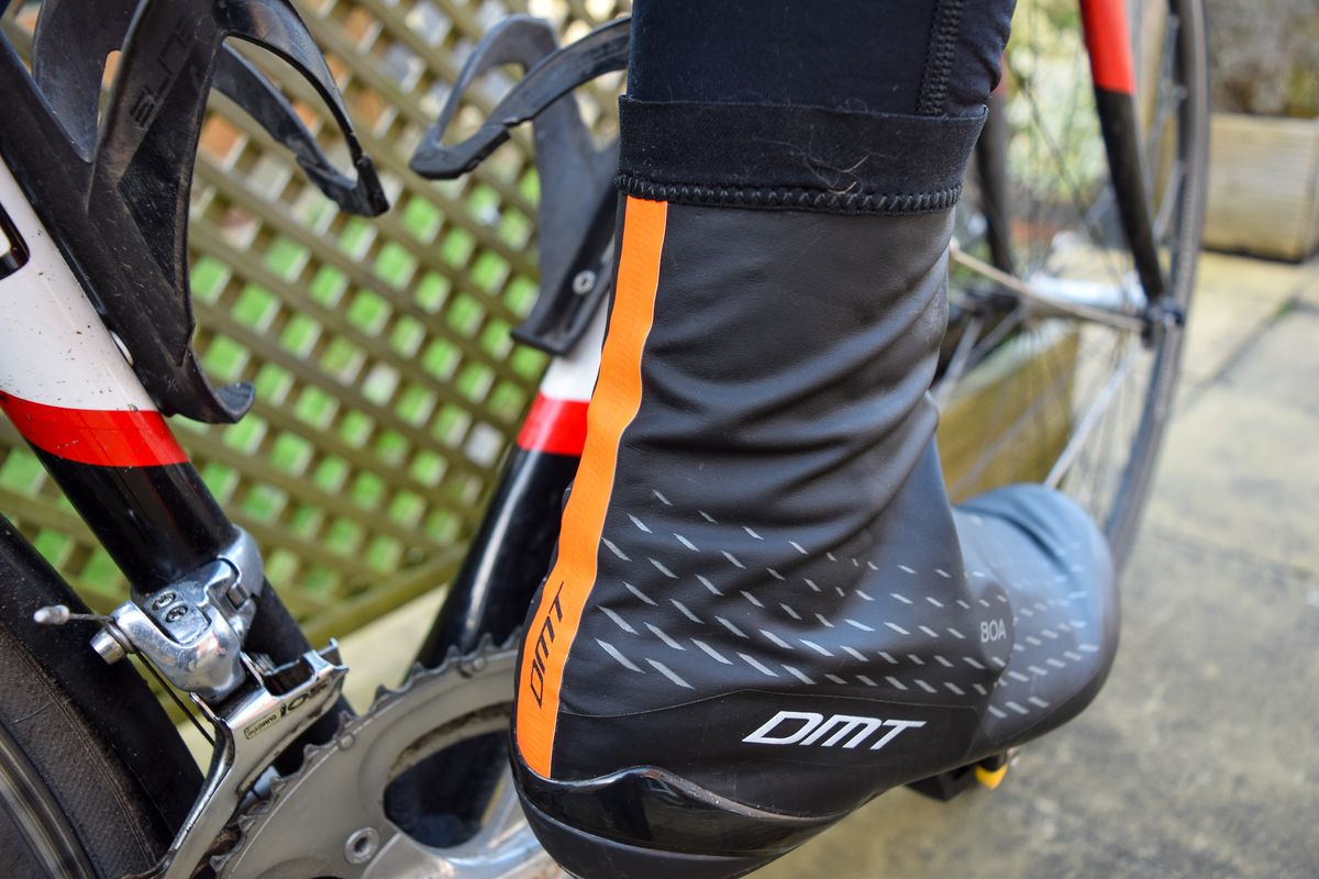 A cyclist wearing a pair of DMT WKR1 shoes