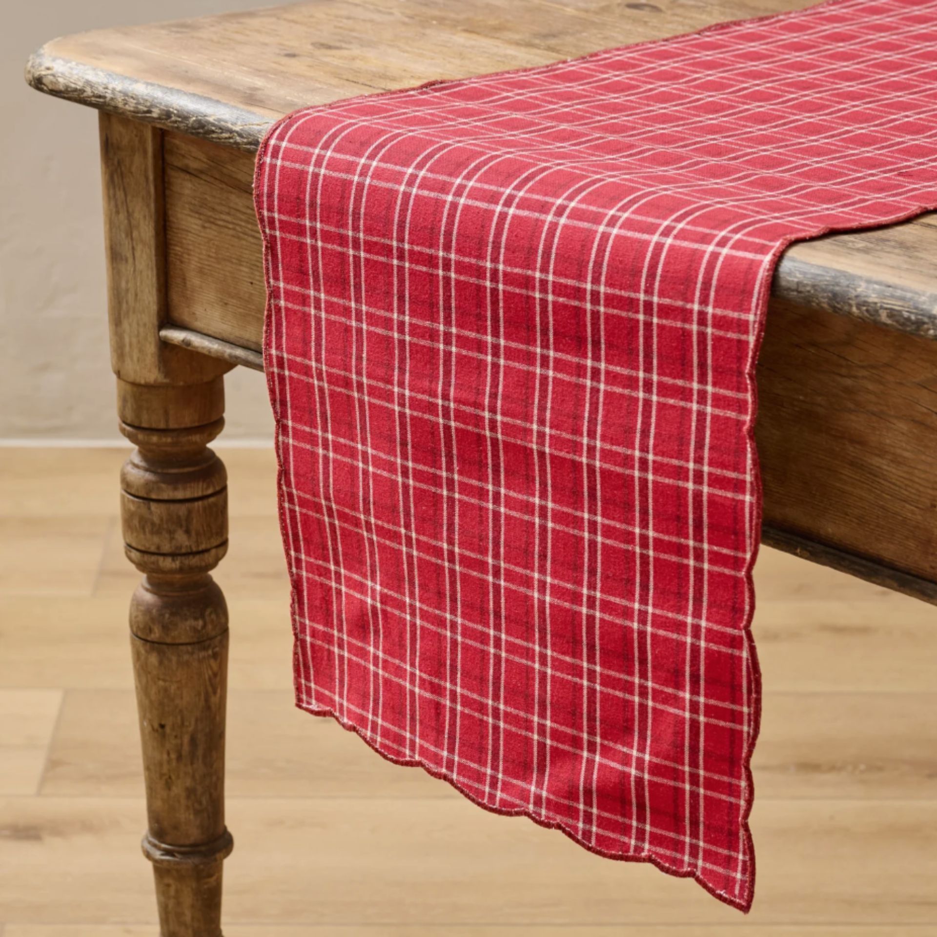 Red plaid table runner with scalloped edge