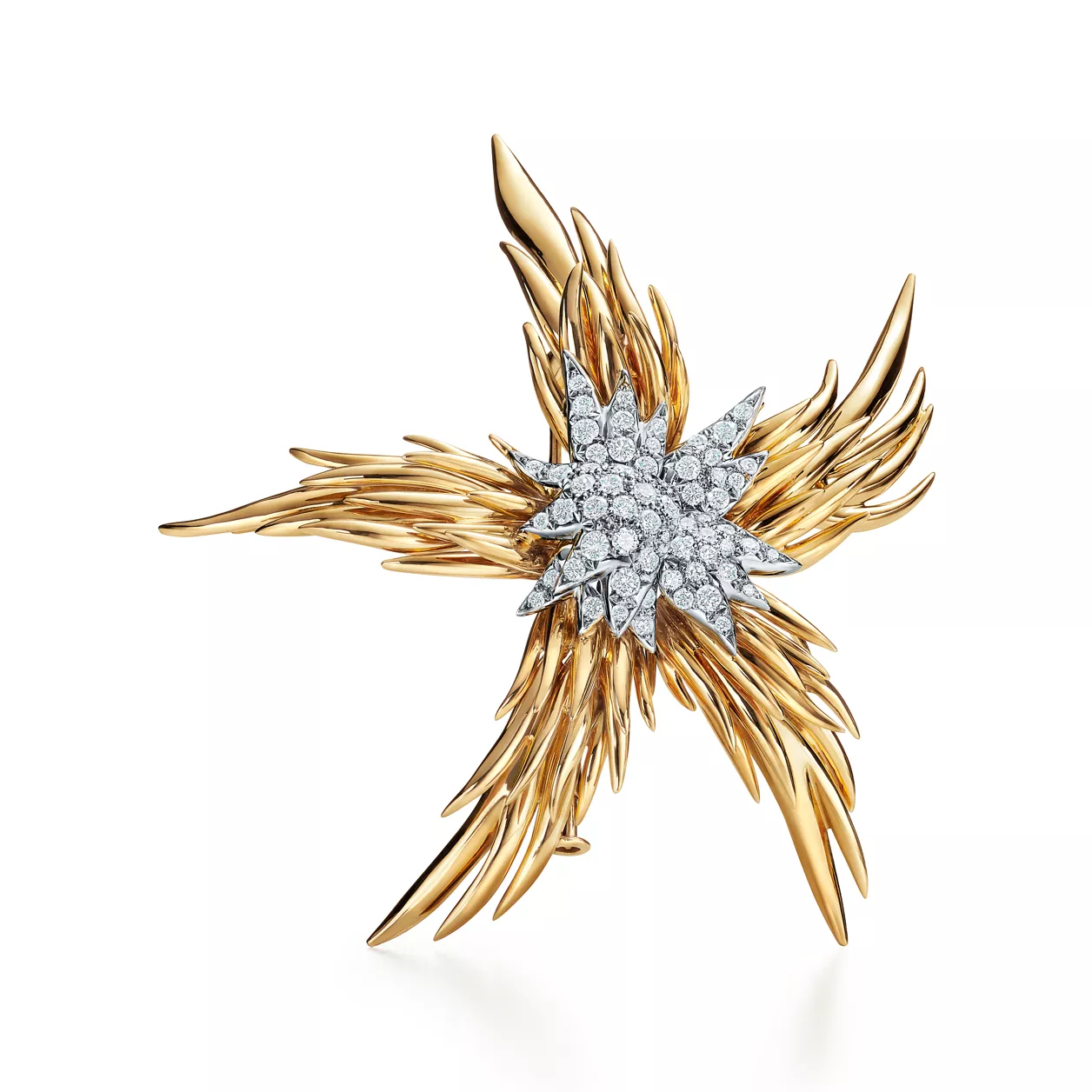A gold star-shaped Paris flame brooch with diamond center by Tiffany &amp;amp; Co