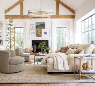 white painted living room with cozy white sofa and a side table with a twine pumpkin on it