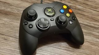 Hyperkin Xbox controller on woodgrain surface