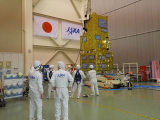 Engineers at the Japan Aerospace Exploration Agency prepare the climate-monitoring spacecraft GOSAT-2 for launch.