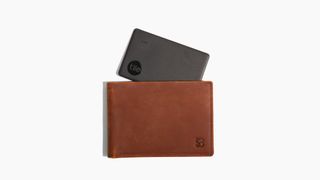 A Tile Slim poking out of a brown men's wallet.