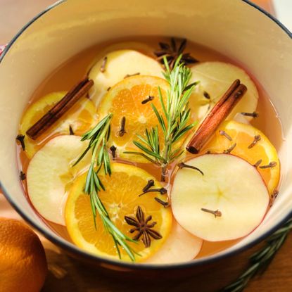 Simmer pot with rosemary, oranges, apples, cloves, and cinnamon