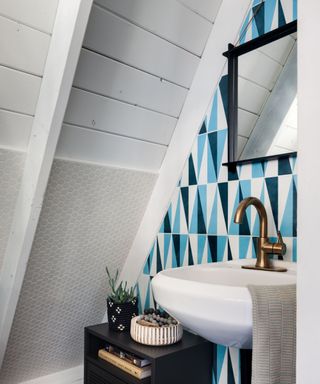 powder room with blue geometric tiles and white pitched roof