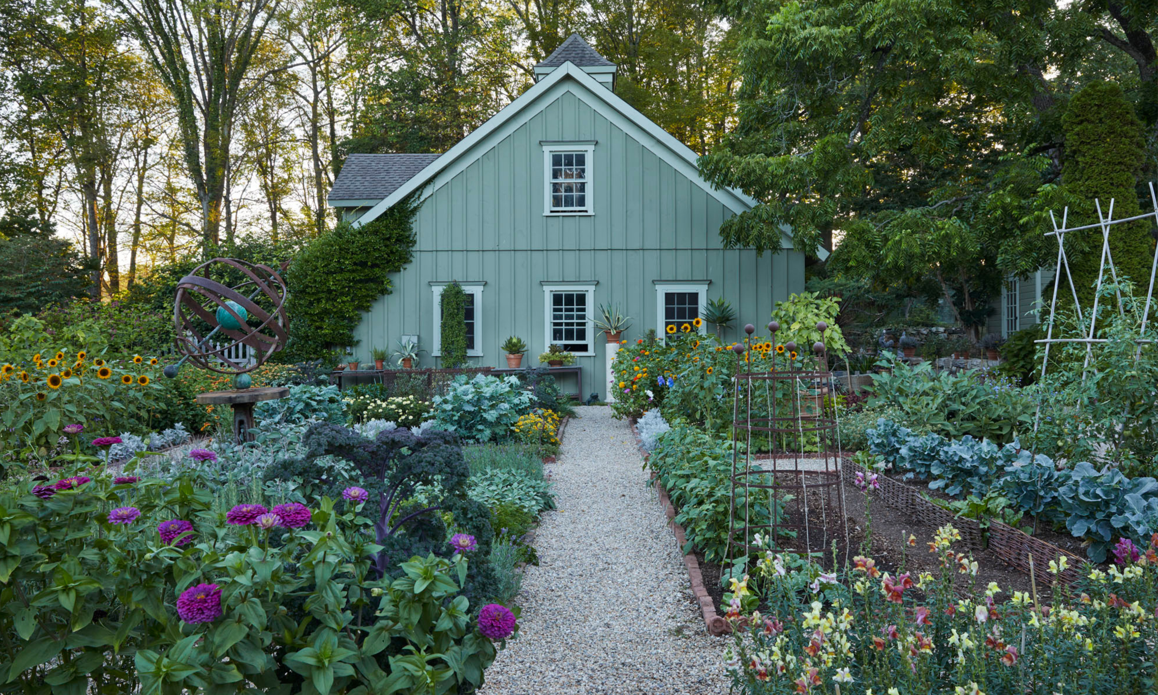 Large kitchen garden with raised beds and cut flowers, with green garden building to rear