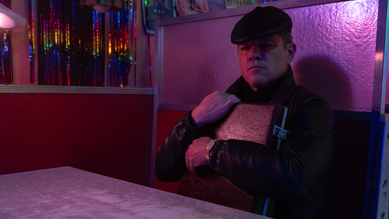 Matt Damon with a briefcase in Drive-Away Dolls
