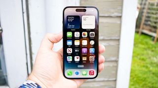 iPhone 14 Pro shown from front displaying iOS16 home screen