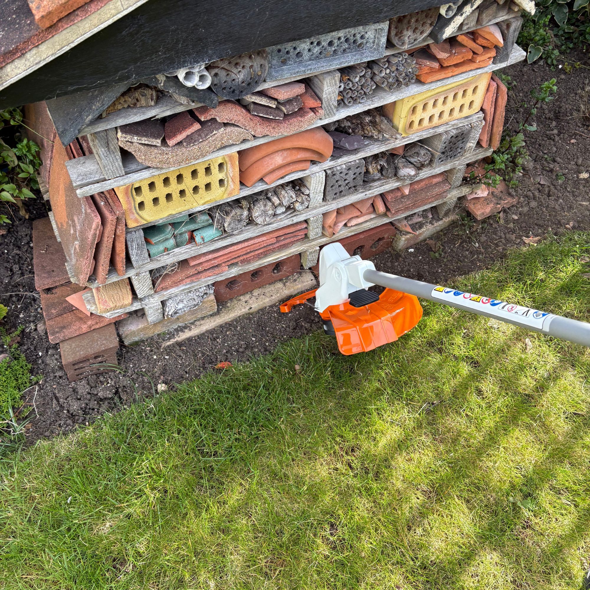 STIHL FSA 50 Cordless Grass Trimmer cutting lawn edge in garden