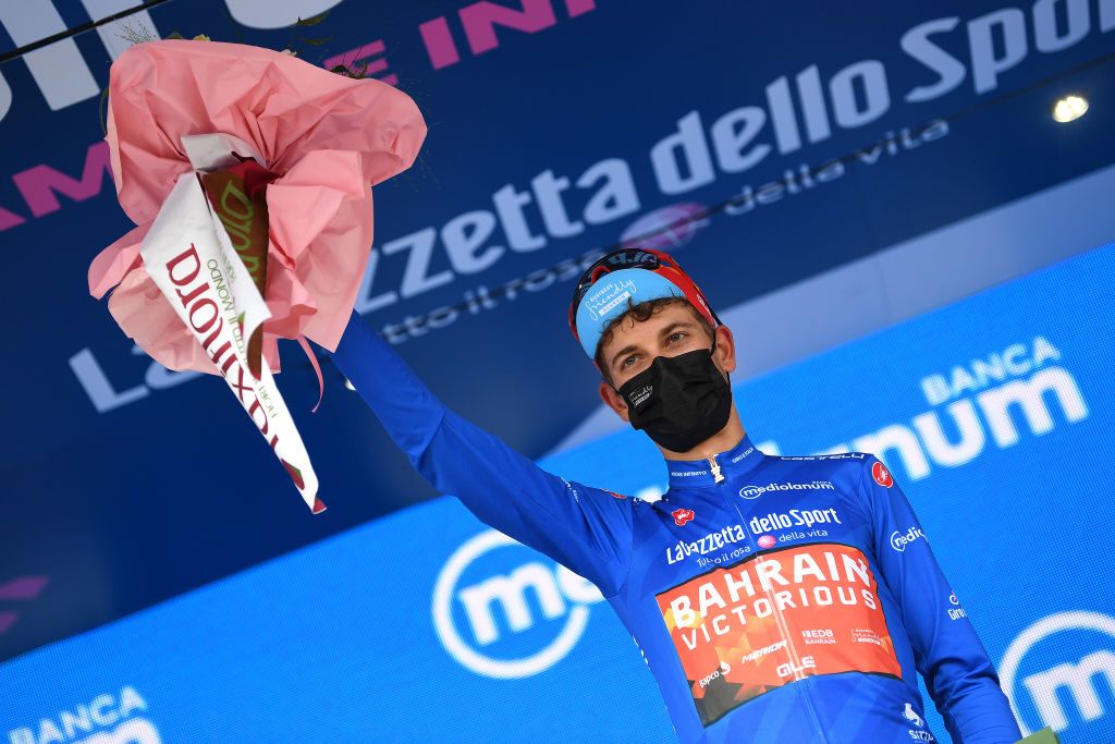 GUARDIA SANFRAMONDI ITALY MAY 15 Gino Mader of Switzerland and Team Bahrain Victorious Team Blue Mountain Jersey celebrates at podium during the 104th Giro dItalia 2021 Stage 8 a 170km stage from Foggia to Guardia Sanframondi 455m Flowers girodiitalia Giro UCIworldtour on May 15 2021 in Guardia Sanframondi Italy Photo by Tim de WaeleGetty Images