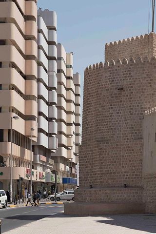 Street view of Bank Street buildings and the Al Hisn Fort Museum.
