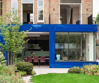 bright blue metal clad exterior on ground floor extension attached to brick house