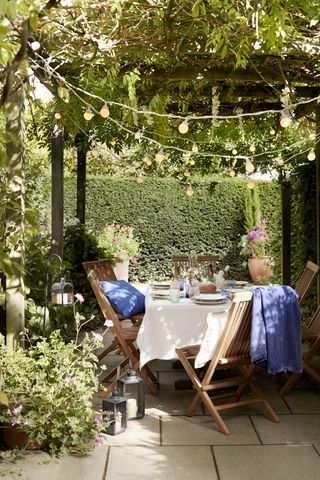 A small outdoor dining room with string lights