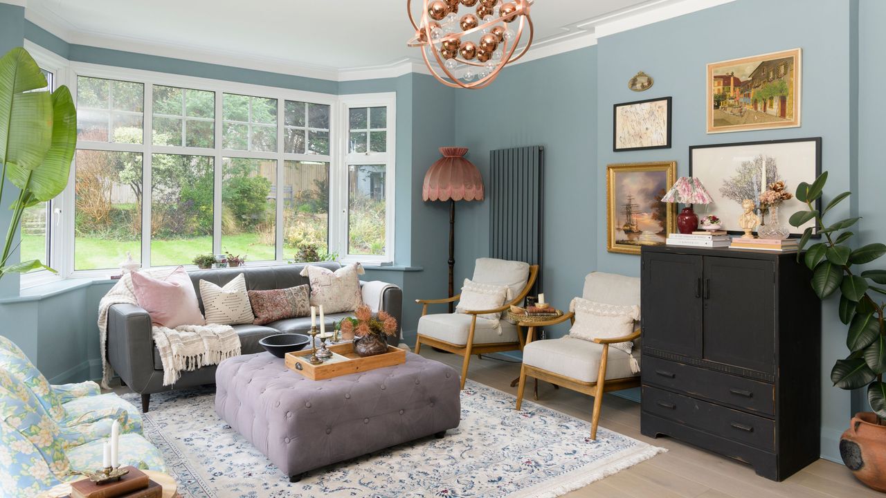 Baby blue living room with vintage pieces of furniture and grey accents