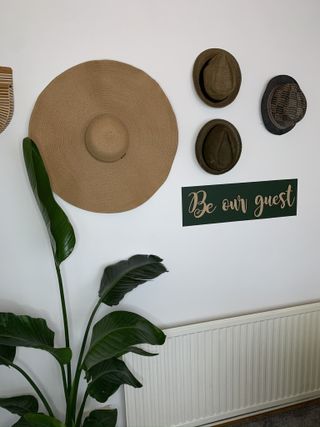 Hats and signage as wall decor on white background